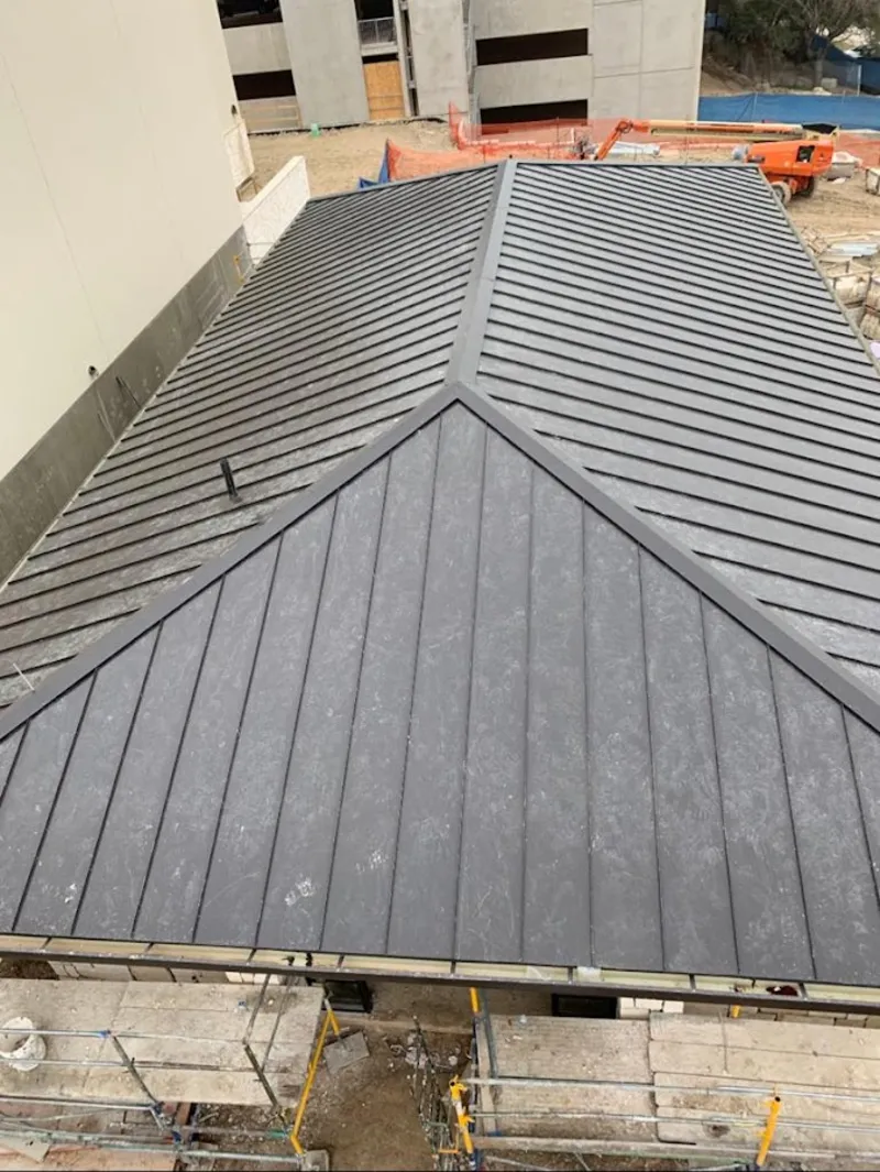 Commercial metal roof construction with crane equipment in Sarasota