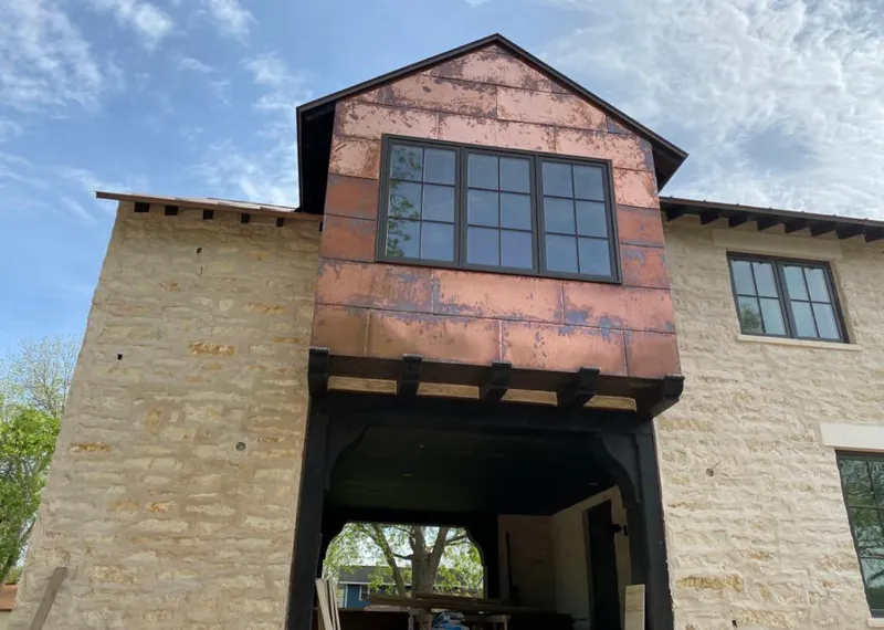 Copper metal panel facade on a stone building for Skylight Installation in Sarasota